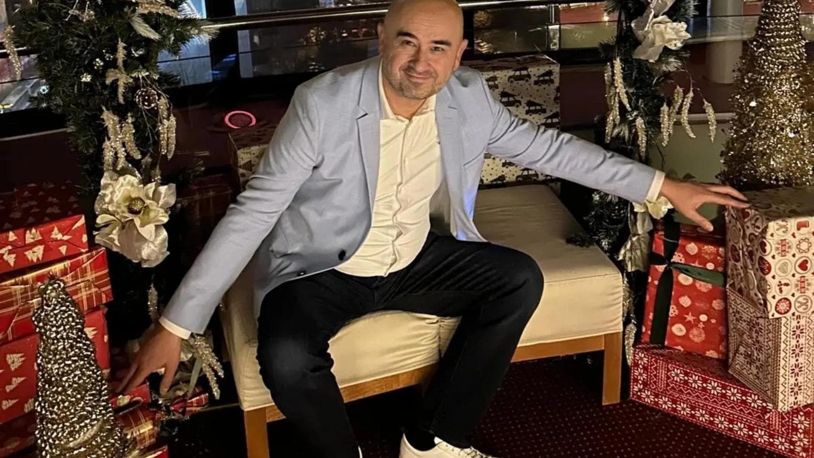 Miljenko Vuković having this picture taken in front of a Chistmas hollidays decor in a bar.