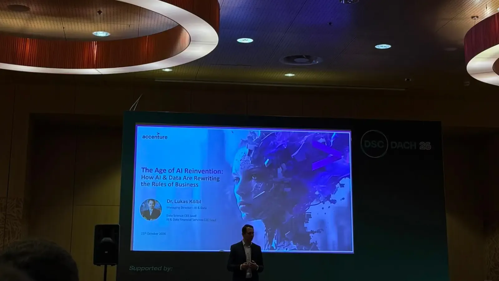 A man presenting on the main stage at DSC DACH 2026.