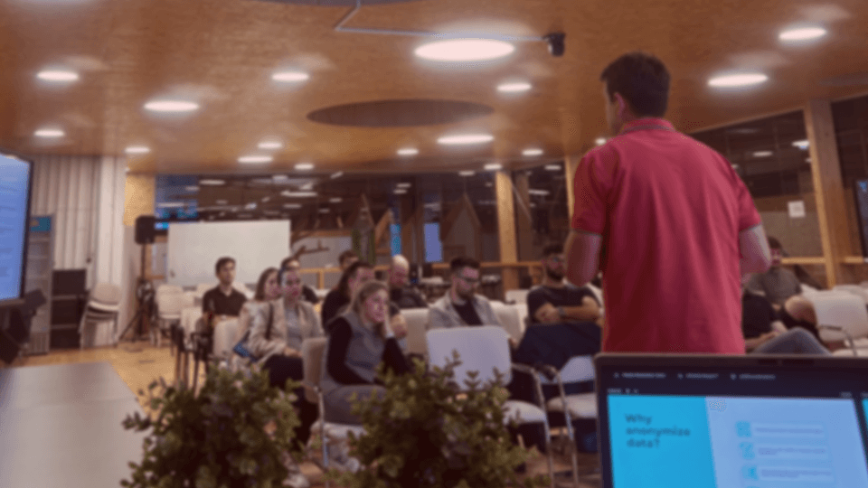 A man giving a presentation at a conference hall.