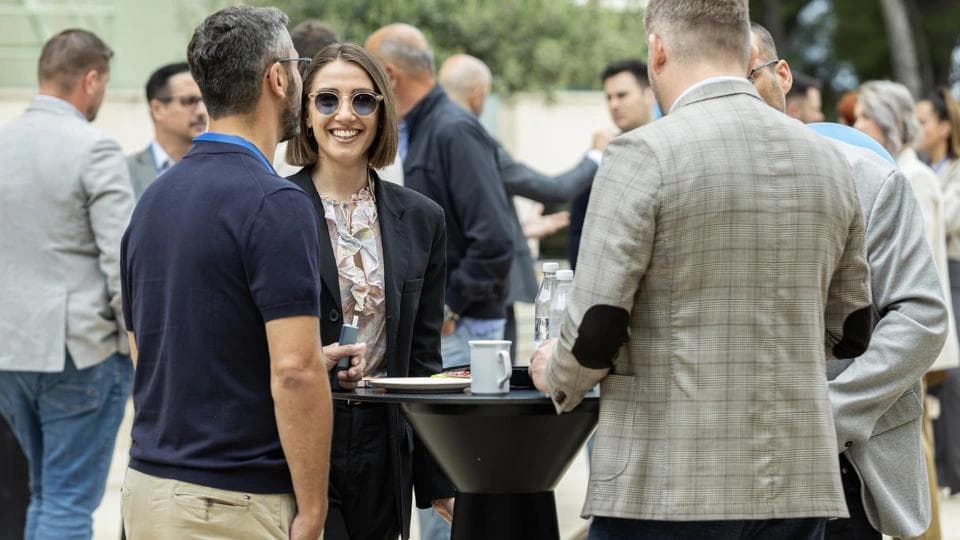 People talking while on a smoking break at an event.