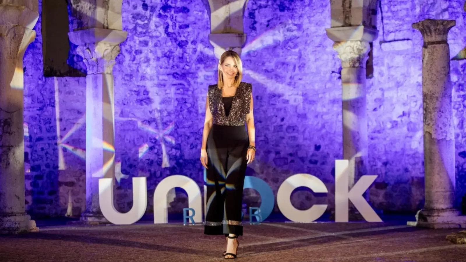 Unlock Rab conference event with a host in front of the main stage.