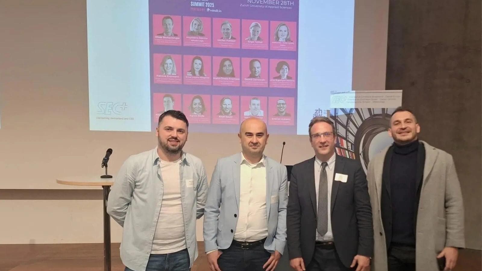 Four businessman taking a picture at a seminar lecture.