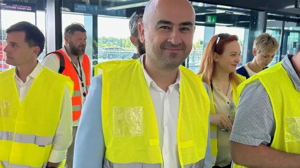 People wearing safety vests during a behind-the-scenes tour of Zagreb Airport terminal facilities.