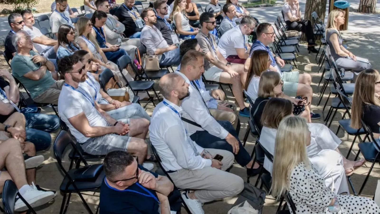 People sitting in an outdoors conference event in the island of Rab.